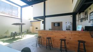 a bar with stools and a table in a building at Mahayahay Lodge and Restaurant in Mactan