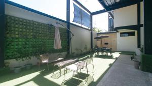 a patio with chairs and an umbrella in a building at Mahayahay Lodge and Restaurant in Mactan +27 photos