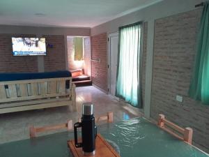 a living room with a table and a tv at Remanso in La Estancia