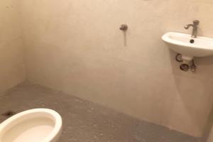 a bathroom with a urinal and a sink at Hotel Villarte Fort Pampanga in San Fernando +33 photos