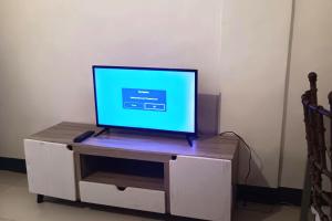 a flat screen tv sitting on top of a white cabinet at Hotel Villarte Fort Pampanga in San Fernando