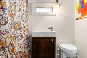 a bathroom with a sink and a toilet at Cozy Tiny Home on an Eco Farm Huge Yard in Austin