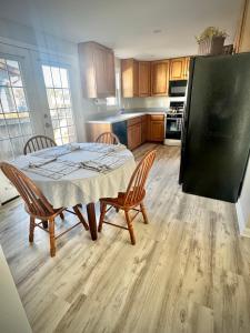 a kitchen with a table and chairs and a refrigerator at Londontowne Hideaway in Annapolis +7 photos