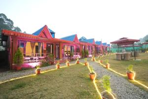 a row of houses with potted plants in front of them at Sol Glow Resort in Bhowāli