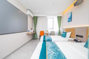 Postel nebo postele na pokoji v ubytování Zhuhai Xiangzhou Yijing Express Hotel