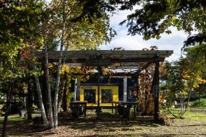 a picnic shelter with a bench in a park at Auberge Sondre in Asahikawa