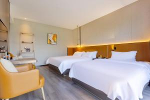 Voodi või voodid majutusasutuse Dujiangyan Yuandong Yaju Hotel toas