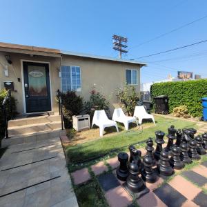 a garden with a giant chessboard in front of a house at 3 bedroom 2 bath home with Jacuzzi near Beverly Hills, wi-fi, Jacuzzi, Roku, BBQ, giant games family fun in Los Angeles