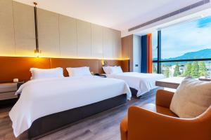 Voodi või voodid majutusasutuse Dujiangyan Yuandong Yaju Hotel toas