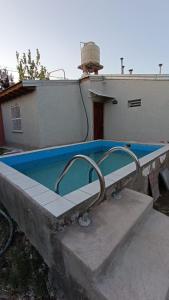 a swimming pool sitting on top of a house at Mi LUGAR EN MALARGÜE in Malargüe