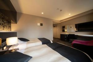 Rúm í herbergi á Hotel Binario Umeda