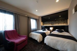 Rúm í herbergi á Hotel Binario Umeda