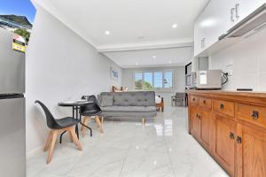 a kitchen with a couch and a table and chairs at Coastal Bliss Studio at Shoal Bay in Shoal Bay