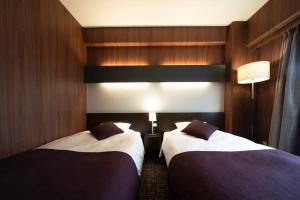 Rúm í herbergi á Hotel Binario Umeda