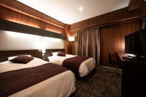 Rúm í herbergi á Hotel Binario Umeda