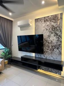 a living room with a large flat screen tv on the wall at Lavender Villa Marc Residence Bukit Mertajam in Bukit Mertajam +45 photos