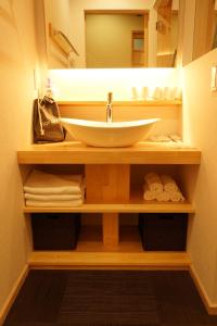 a bathroom with a sink and a mirror at VILLA East West in Nara