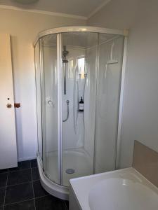 a bathroom with a shower and a sink at Atawhai Retreat Peace & Sea Views in Nelson +29 photos