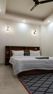 a bedroom with a bed and two lights on the wall at Homestay at Rishikesh - 1BHK Apartment in Rishīkesh