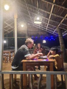a group of people sitting at a table at La-Vira Beach Villa in Hikkaduwa