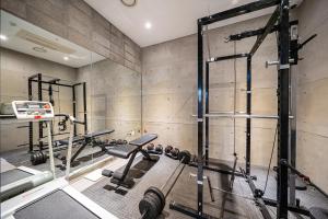 a gym with several tread machines and a mirror at Gong-Ju TouristHotel INK in Gongju