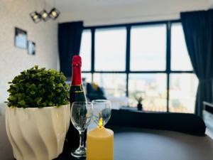 a bottle of wine and a candle on a table at Sea & City View New Condo in Georgetown 3br 10 pax in George Town