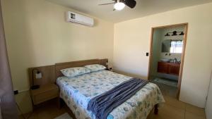a bedroom with a bed and a dresser and a mirror at Casa Mi Puerto in Puerto Jiménez