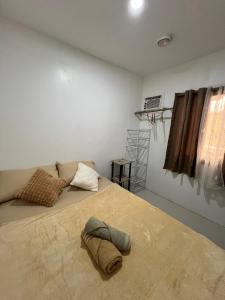 a bedroom with a large bed and a window at Casa Mia in El Nido