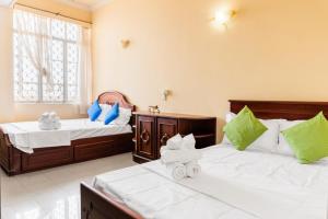 Postel nebo postele na pokoji v ubytování Asian Rooms Colombo 14