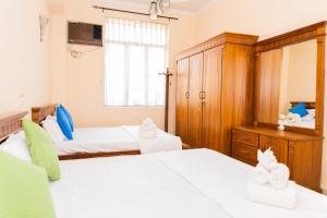Postel nebo postele na pokoji v ubytování Asian Rooms Colombo 14