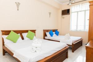 Postel nebo postele na pokoji v ubytování Asian Rooms Colombo 14