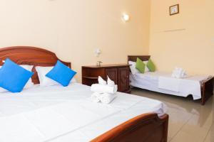 Postel nebo postele na pokoji v ubytování Asian Rooms Colombo 14