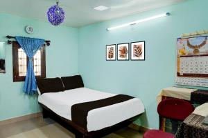 Ένα ή περισσότερα κρεβάτια σε δωμάτιο στο Hotel O PARAM HOMESTAY