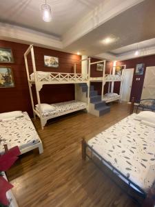 a room with three bunk beds and a staircase at Country Home Resort in Oslob +11 photos
