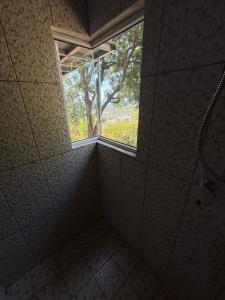 a bathroom with a window and a walk in shower at Punta Roca View 2 in La Libertad
