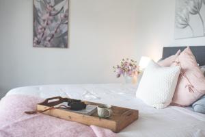 a tray with a camera and a cup on a bed at kentonviewsestate in Gumeracha