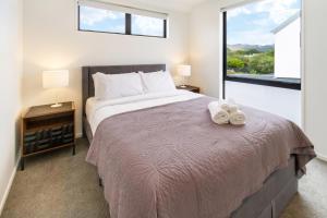 a bedroom with a large bed and a window at Affordable Comfort 2BR with Carpark in Christchurch