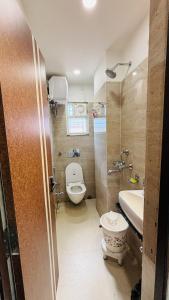 a small bathroom with a toilet and a sink at Hotel Vivaanta in Dhanbād +45 photos