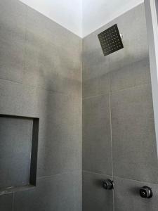 a bathroom with a shower with a shower head at Departamento San Cristóbal in Mexico City