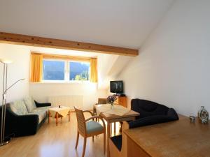 a living room with a couch and a table at Apartment in Zugspitz Arena near Cycle Path in Bichlbach