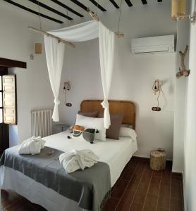 a bedroom with a bed with two towels on it at Hotel La Casa del Canónigo in Caracenilla