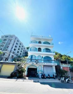 a large white building with motorcycles parked in front of it at Xing Ocean Vũng Tàu in Vung Tau