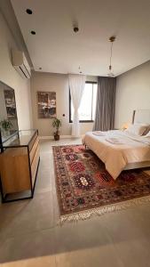 a bedroom with a large bed and a glass table at Luxury Three Bedroom Apartment with Trans in Riyadh
