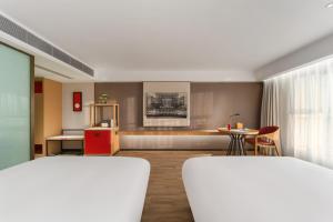 a living room with a couch and a table at Madison Hotel, Qingdao Laoshan Polar Ocean Park in Qingdao +38 photos
