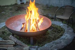 a fire in a pot with flames in it at プライベートリゾート富士 in Yamanakako