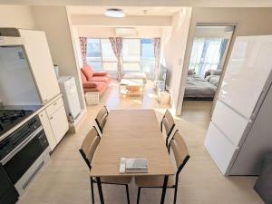 a dining room with a table and chairs in a room at Chateau Sunrise in Tokyo