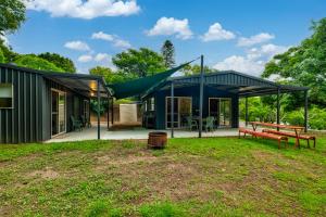 a house with a green roof and a bench at The Archer Retreat in Villeneuve
