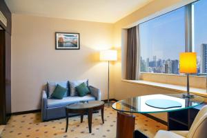 a hotel room with a couch and a glass table at Radisson Collection Hyland Shanghai in Shanghai