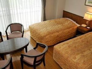 Postel nebo postele na pokoji v ubytování 奥伊勢フォレストピア