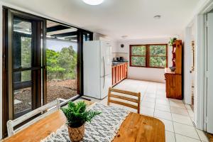 a kitchen and dining room with a table and a refrigerator at The Archer Retreat in Villeneuve